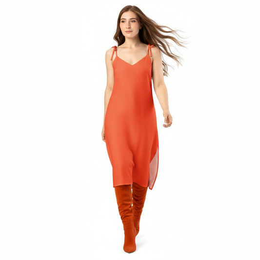 Woman wearing an orange slip dress on a white background