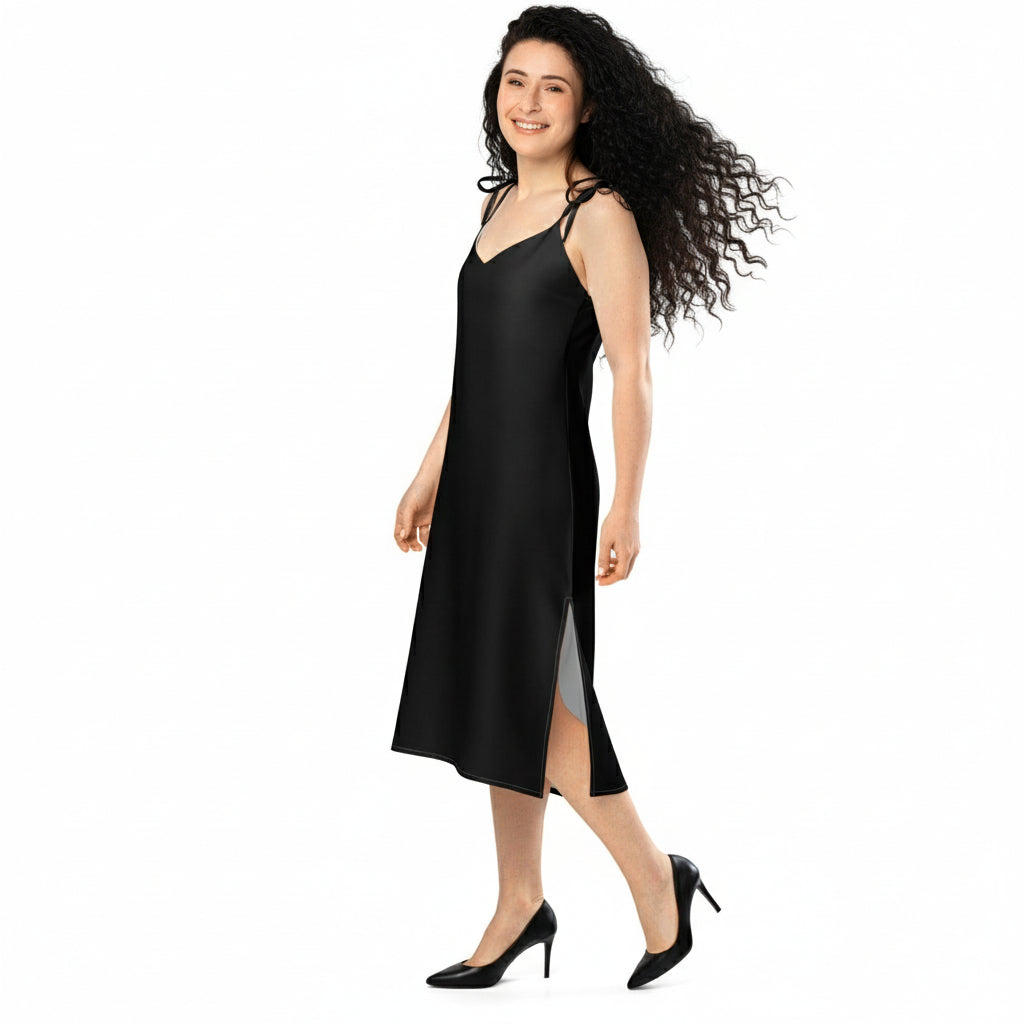 Woman wearing a black slip dress on a white background