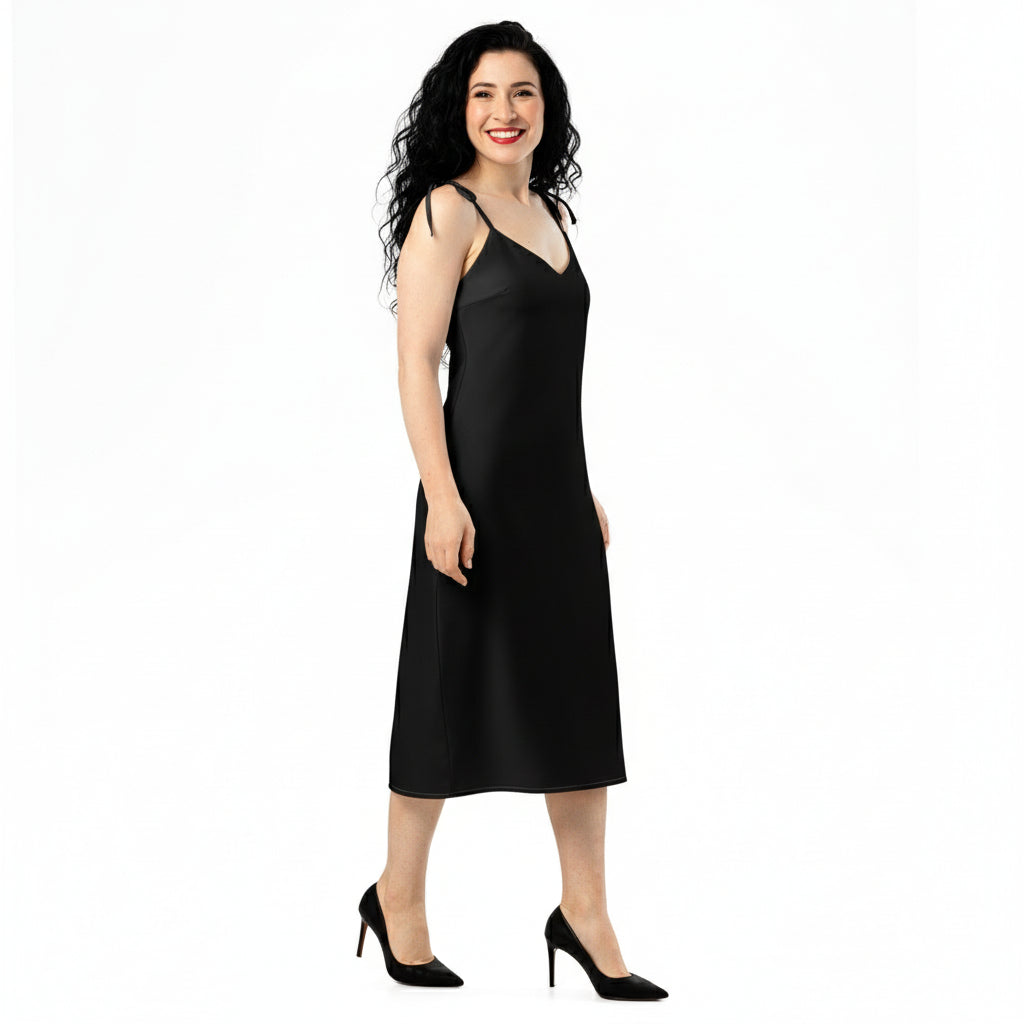 Woman wearing a black slip dress on a white background
