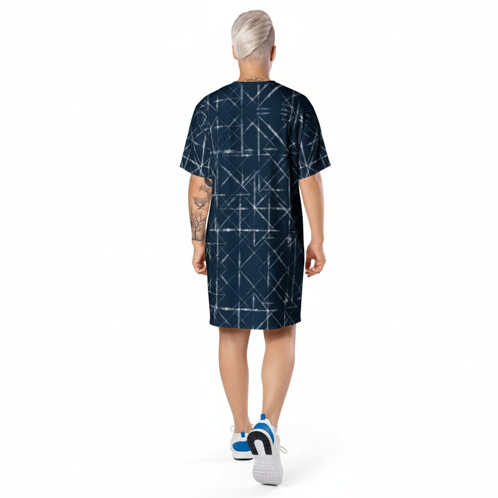Person wearing a dark blue dress with geometric pattern on a white background
