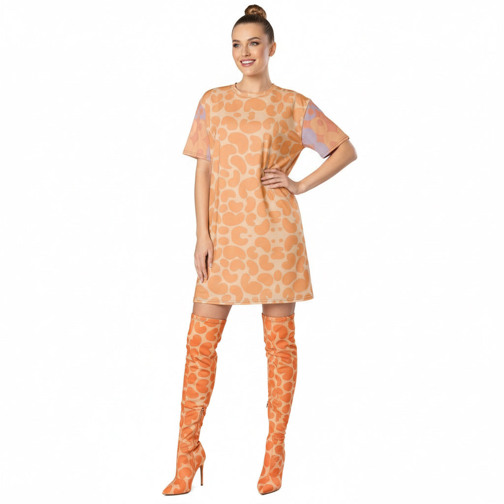 Person wearing a peach fuzz KhuKhuZ patterned dress on a white background