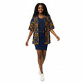 Woman wearing a colorful patterned shirt and navy skirt against a plain background