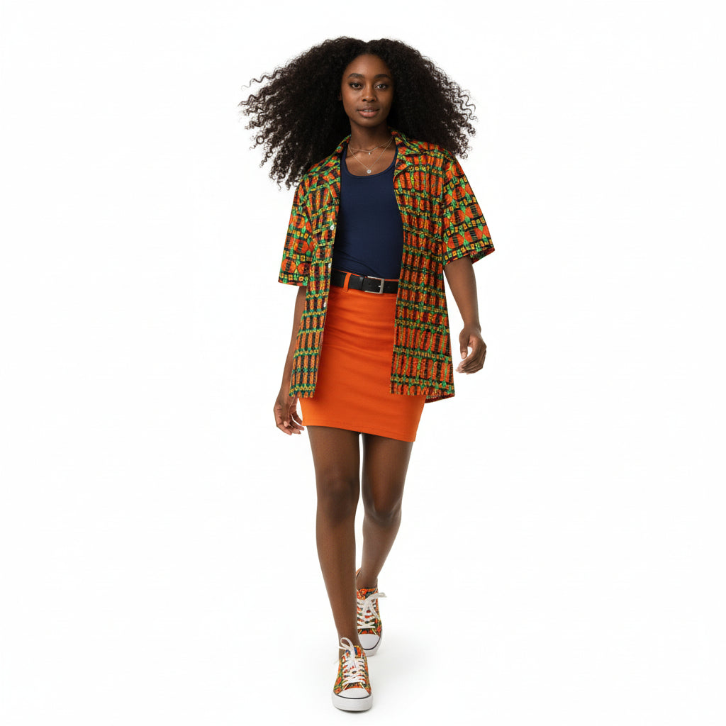 Person wearing a colorful patterned jacket and mini skirt walking against a plain background