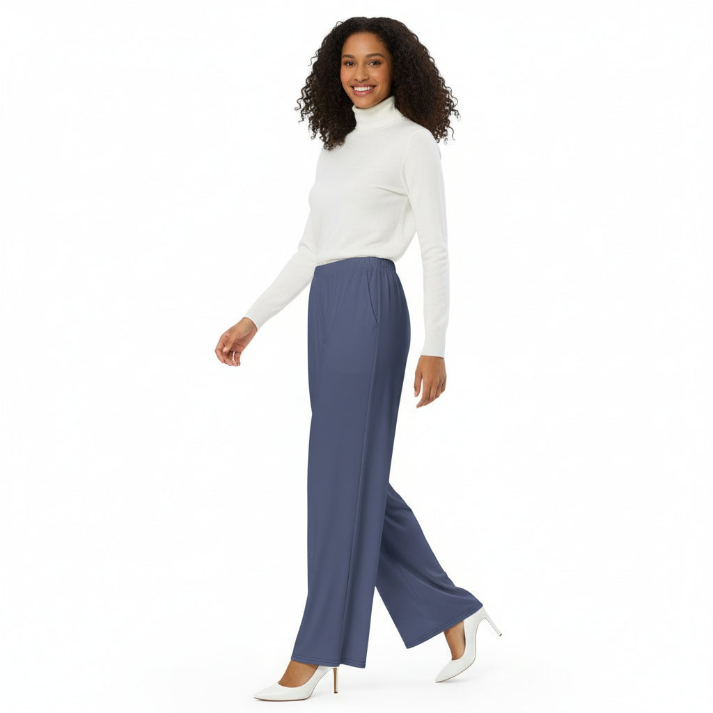 Woman wearing a white sweater and blue pants on a white background