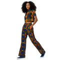 Woman wearing colorful patterned pants and a white crop top on a white background