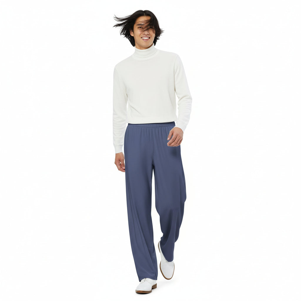 Person wearing a white turtle neck sweater and blue pants on a white background