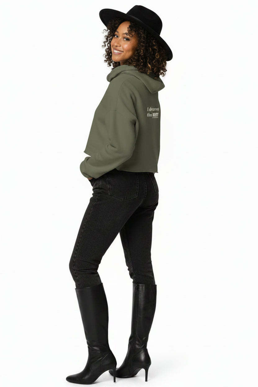 Woman wearing a green hoodie and black pants on a white background