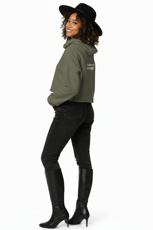 Woman wearing a green hoodie and black pants on a white background