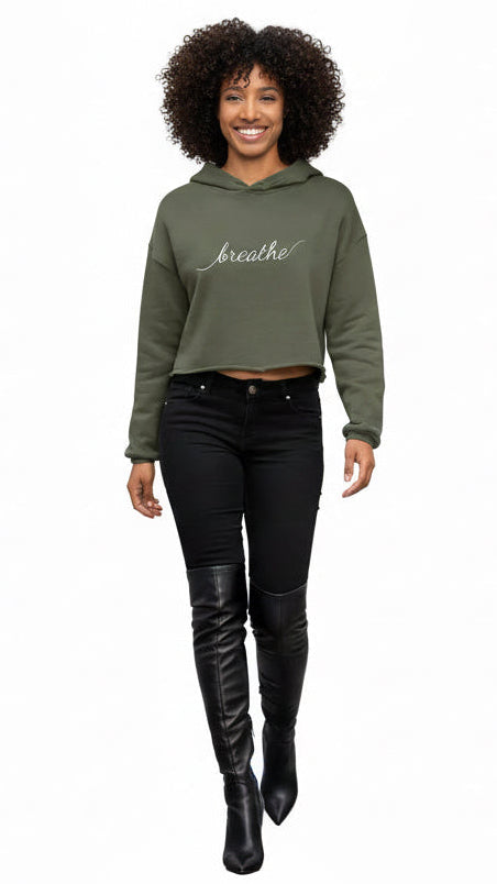 Woman wearing a green hoodie with 'breathe' text on a white background