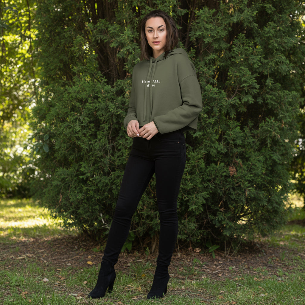 Woman wearing a green hoodie with text on a bushy background