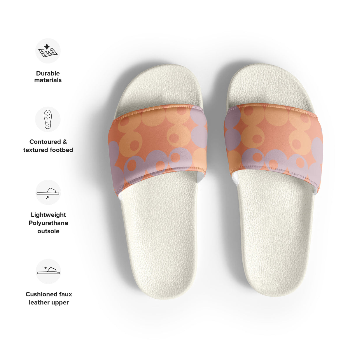 A pair of slide sandals shown from above on a white background, with feature callouts on the left. The sandals have textured off-white footbeds and wide straps with a retro pattern of orange, peach, and lavender circles.